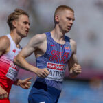 Ben Pattinson competes in the men's 800m semi-finals. He is white with short ginger hair and is wearing a blue striped race suit.