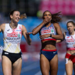 Lina Nielsen covers her mouth in surprise after finishing the women's 400m hurdles at Birmingham 2026. Nielsen is wearing a blue sports bra and blue bottoms.