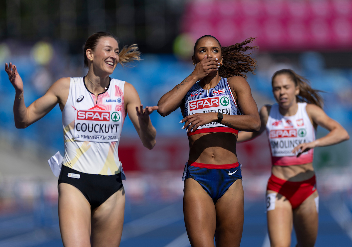 Lina Nielsen covers her mouth in surprise after finishing the women's 400m hurdles at Birmingham 2026. Nielsen is wearing a blue sports bra and blue bottoms.